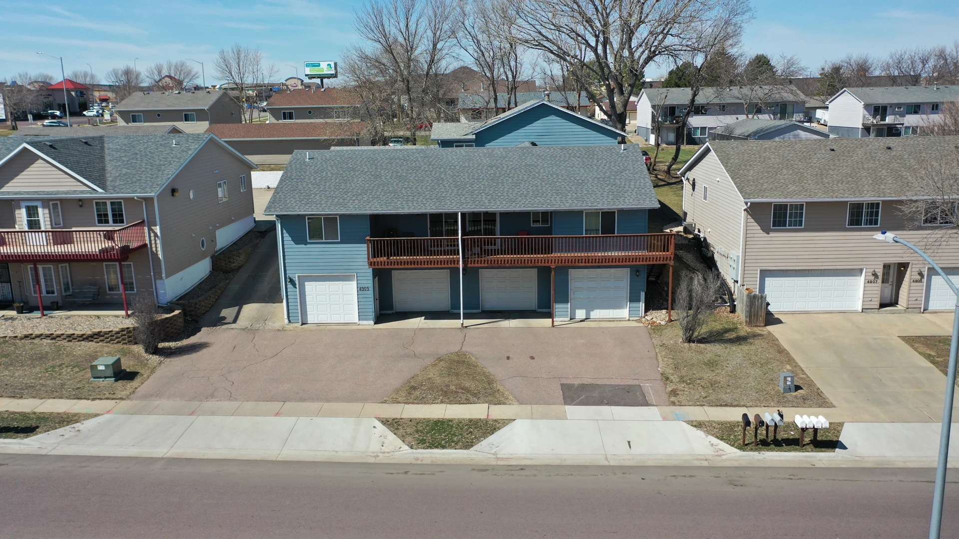 4909 S. Tennis Lane, one of the two Metastone Estates buildings. Original company photograph from 2021.
